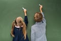 Pupils writing on chalkboard