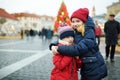 Two adorable sisters having wonderful time on traditional Christmas market.