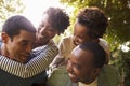 Two adult black couples have fun piggybacking, close up Royalty Free Stock Photo