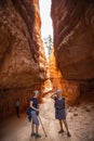 Two adult women hiking and taking pictures in Bryce Canyon National Park, Utah, USA while on vacation. Candid photo