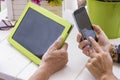 Internet leisure activity outdoor in the terrace at home for couple of women using technology