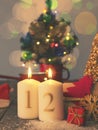 Two Advent candles burning with gift boxes, vintage tone stylized Royalty Free Stock Photo