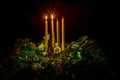 Two advent candles burning on advent wreaths Royalty Free Stock Photo
