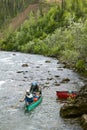 Adventurous men in a canoe on wild river rapids