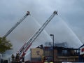 Two Aerial Ladders Aim Their Water Cannons