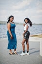 Two african american dark skinned friends female. One of them plus size model, second slim. Having fun and spending time together Royalty Free Stock Photo