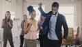 Two African American friends doing dance moves together at office party. Multiethnic business people have fun at work 4K Royalty Free Stock Photo