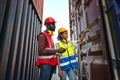 Two African american male and female worker check and control loading freight containers from Cargo freight ship for import export Royalty Free Stock Photo