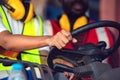 Two African American male and female worker in uniform and helmet driving and operating on diesel container forklift truck at Royalty Free Stock Photo