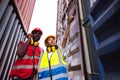 Two African american male and female worker using radio communication and checking control loading freight containers from Cargo Royalty Free Stock Photo