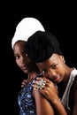 Two African American Sisters In Headscarfs On Dark Background