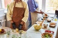 Two African American women doing food prep in kitchen Royalty Free Stock Photo