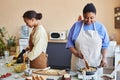 Two African American women doing food prep in kitchen cooking together Royalty Free Stock Photo