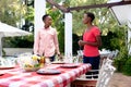 Two African American women preparing a family dinner in the garden Royalty Free Stock Photo