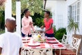 Two African American women preparing a family dinner in the garden Royalty Free Stock Photo