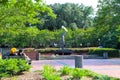 Two African American women sitting on a park bench in front of the Waving Girl Statue by Felix De Weldon standing in Morrell Park Royalty Free Stock Photo