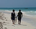 Two African boys on stunning beach in Zanzibar with fish they caught