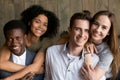 Two african and caucasian couples embracing looking at camera, p Royalty Free Stock Photo