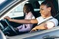 Two african female friends on road trip driving in the car Royalty Free Stock Photo