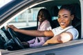 Two african female friends on road trip driving in the car Royalty Free Stock Photo