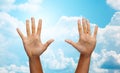 Two african hands making high five over blue sky Royalty Free Stock Photo