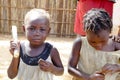 Two african kids eating mandioca with their own hands