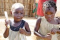 Two african kids eating mandioca with their own hands