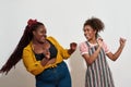 Two afro women dancing and looking at each other