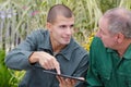 two agricultural engineers analyze data with tablet computer Royalty Free Stock Photo