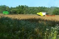 Two agricultural machines operate in the field, grain harvesting machines operate in the field, agricultural land Royalty Free Stock Photo