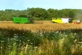 Two agricultural machines operate in the field, grain harvesting machines operate in the field, agricultural land Royalty Free Stock Photo