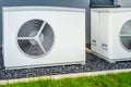 Two air source heat pumps installed outside of new and modern city house Royalty Free Stock Photo