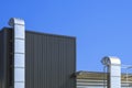 Two air ventilation ducts outside of modern industrial building against blue sky Royalty Free Stock Photo