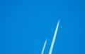 Two airplane with white condensation tracks. Jet plane on clear blue sky with vapor trail. Travel by aeroplane concept. Trails of Royalty Free Stock Photo