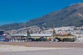 Two airplanes abandoned, this space used to be an airport. Behind a nice view of the city and a mountain Royalty Free Stock Photo