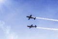 Two airplanes doing airshow in the sky Royalty Free Stock Photo