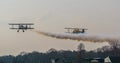 Two airplanes taking off with smoking engines, show and stunt planes flying in the sky Royalty Free Stock Photo