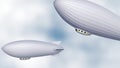 two airships or dirigible balloons in the sky