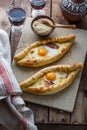 Two ajarian khachapuri, georgian bread with cheese and yolk