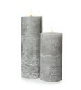 Two alight wax candles on white Royalty Free Stock Photo