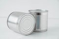 Two aluminum closed metal cans on a white table. Copy, empty space for text Royalty Free Stock Photo