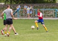 Two amateur football teams play on the field in