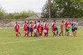 Two amateur football teams play on the field in