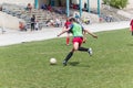 Two amateur football teams play on the field in