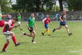 Two amateur football teams play on the field in