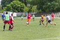 Two amateur football teams play on the field in