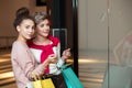 Young woman showing something in the shop window to her husband Royalty Free Stock Photo