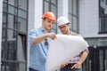 Two ambitious engineers are developing own ideas to create skyscraper Royalty Free Stock Photo