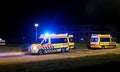 Two Ambulances with flashing blue lights in the Netherlands at incident location.