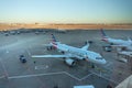 two american airlines planes parked at DFW International airport with the runway behind during sunset Royalty Free Stock Photo